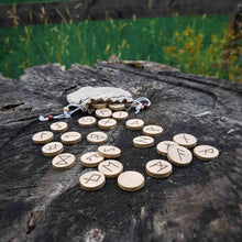 Load image into Gallery viewer, Hazel wood Elder Futhark rune set hand-engraved in pyrography and handcrafted organic linen pouch Misty Stroll